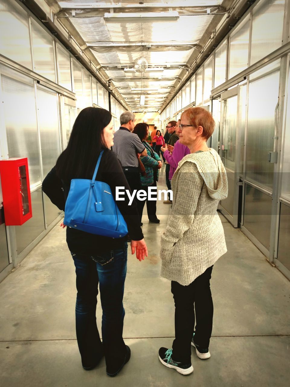 FRIENDS STANDING ON CORRIDOR OF BUS