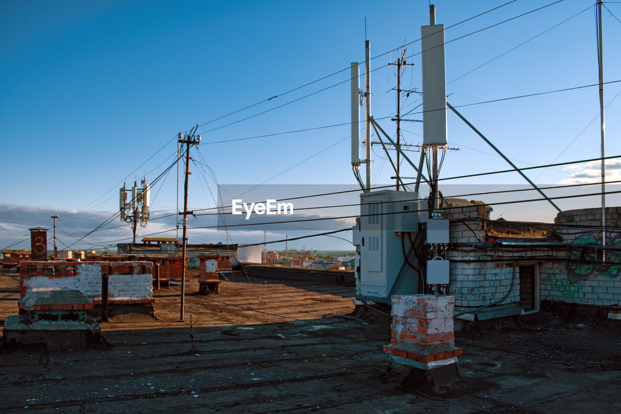 Metallic structure by building against clear blue sky