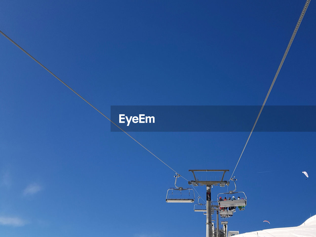 LOW ANGLE VIEW OF POWER LINES AGAINST BLUE SKY