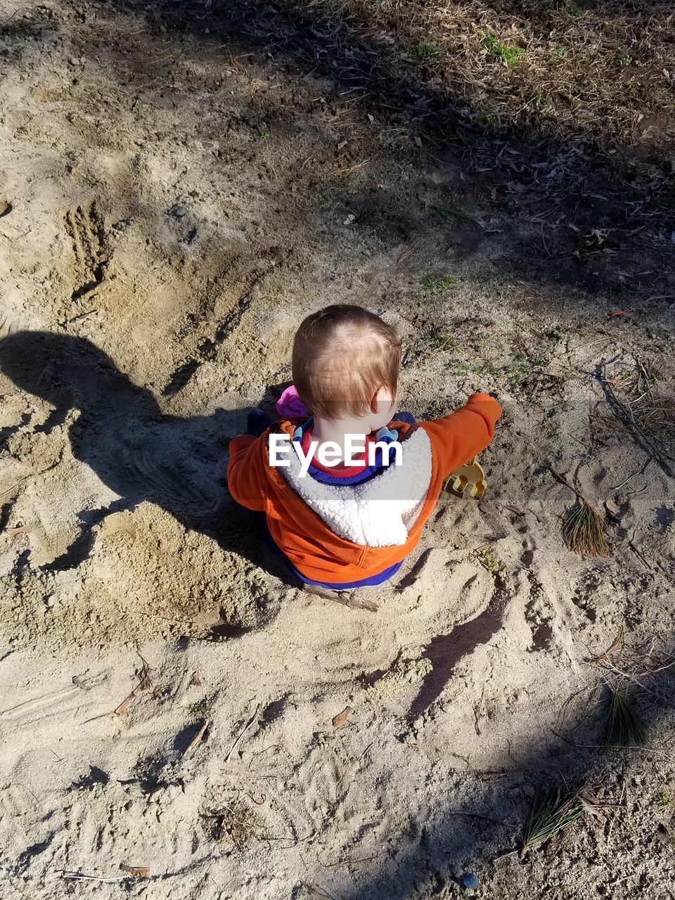 HIGH ANGLE VIEW OF BOY ON FIELD AT LAND