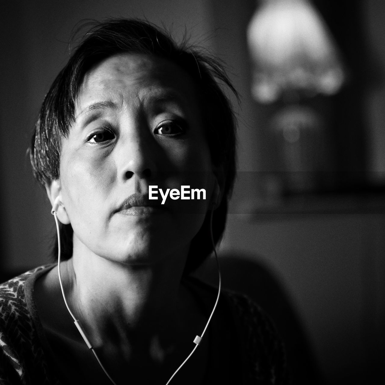 Close-up portrait of mid adult chinese woman at home