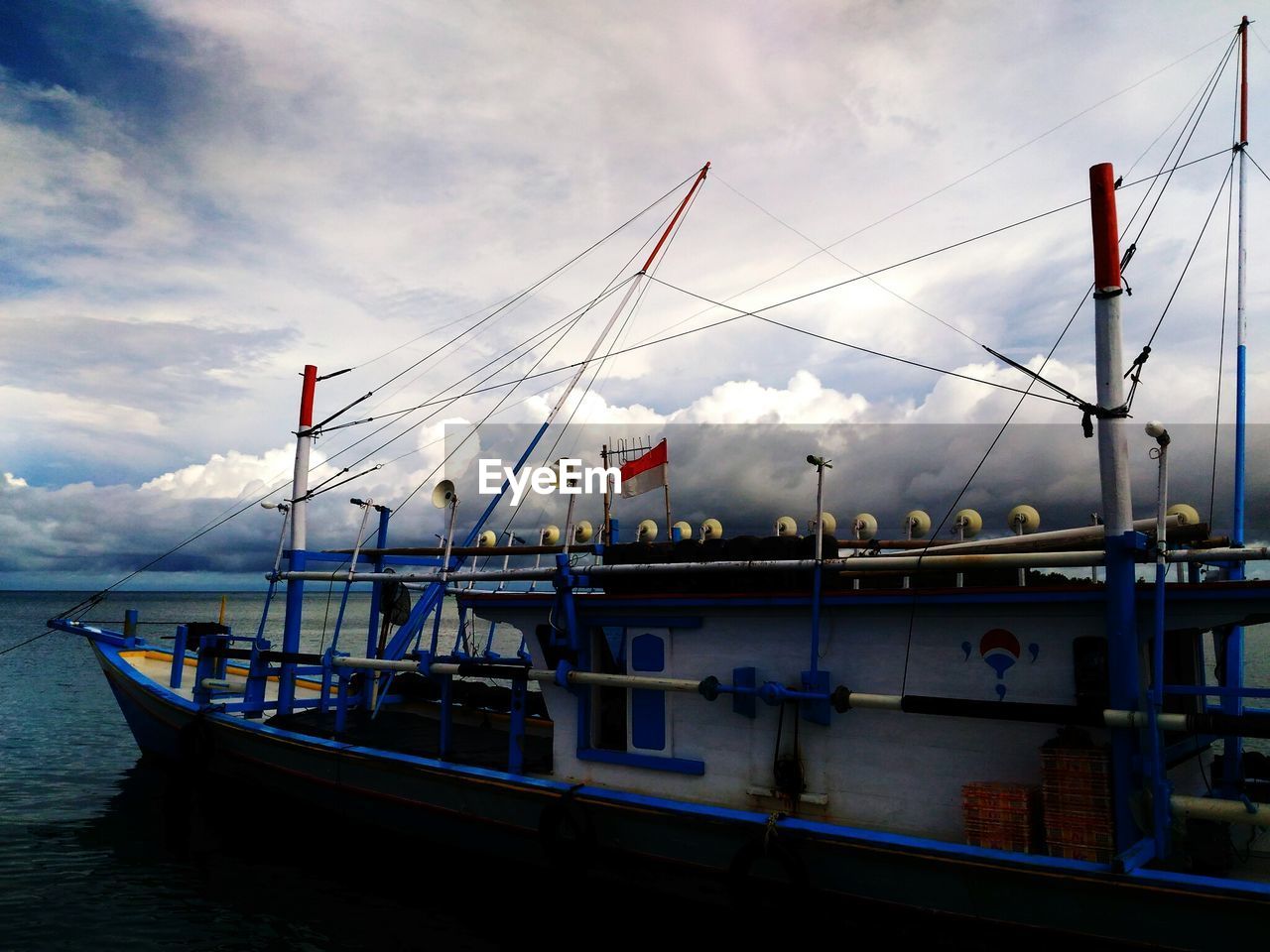 SCENIC VIEW OF HARBOR AGAINST SKY