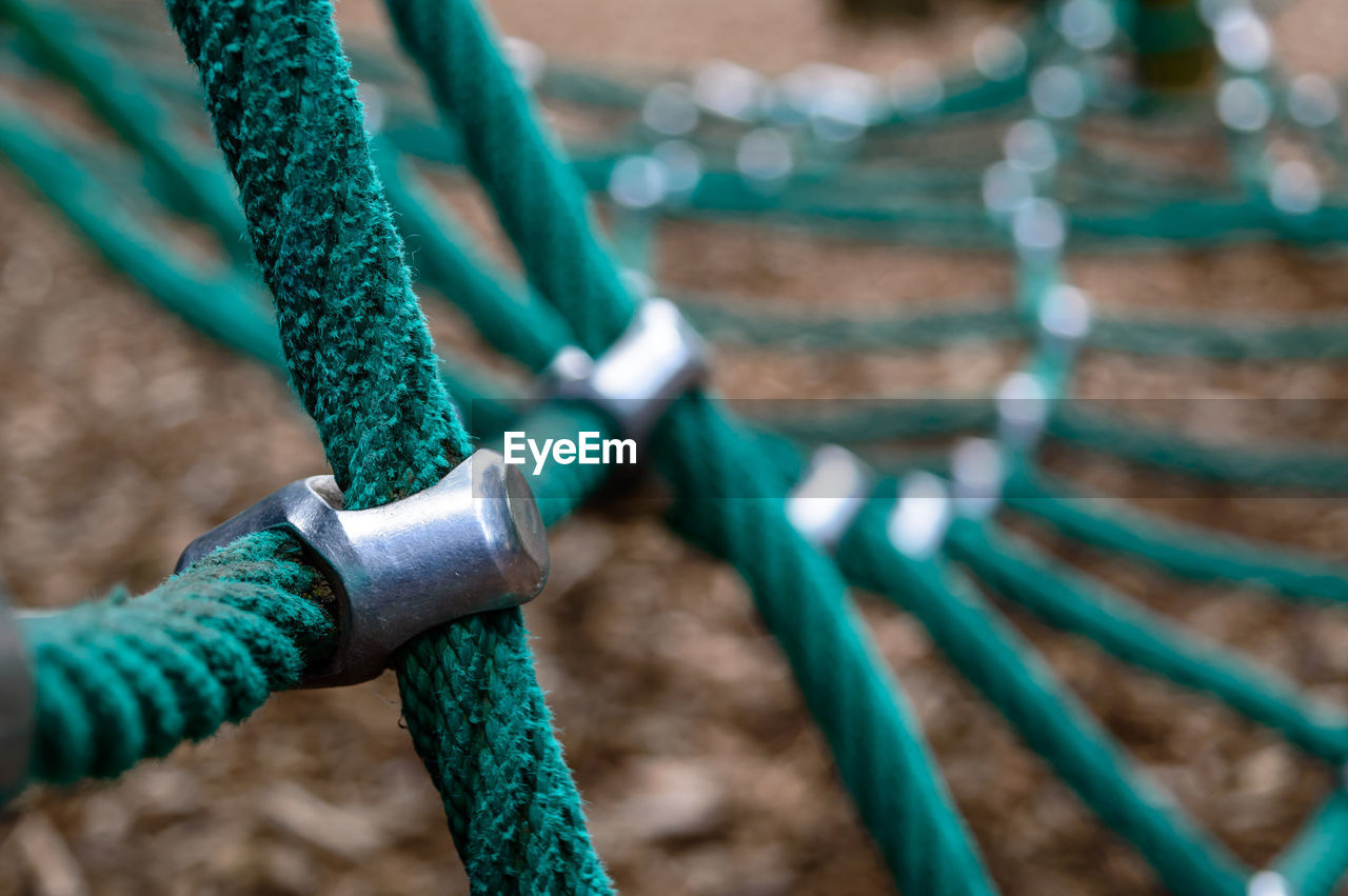 Cropped image of green rope equipment in playground