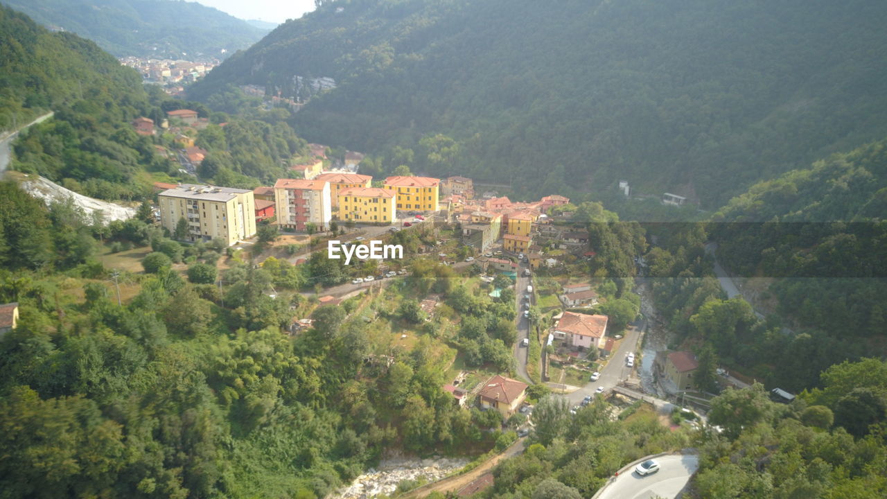 HIGH ANGLE VIEW OF TOWNSCAPE BY TREES