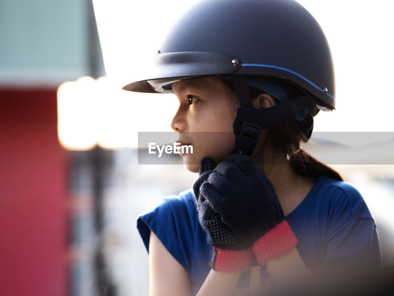 Close-up of girl wearing helmet looking away