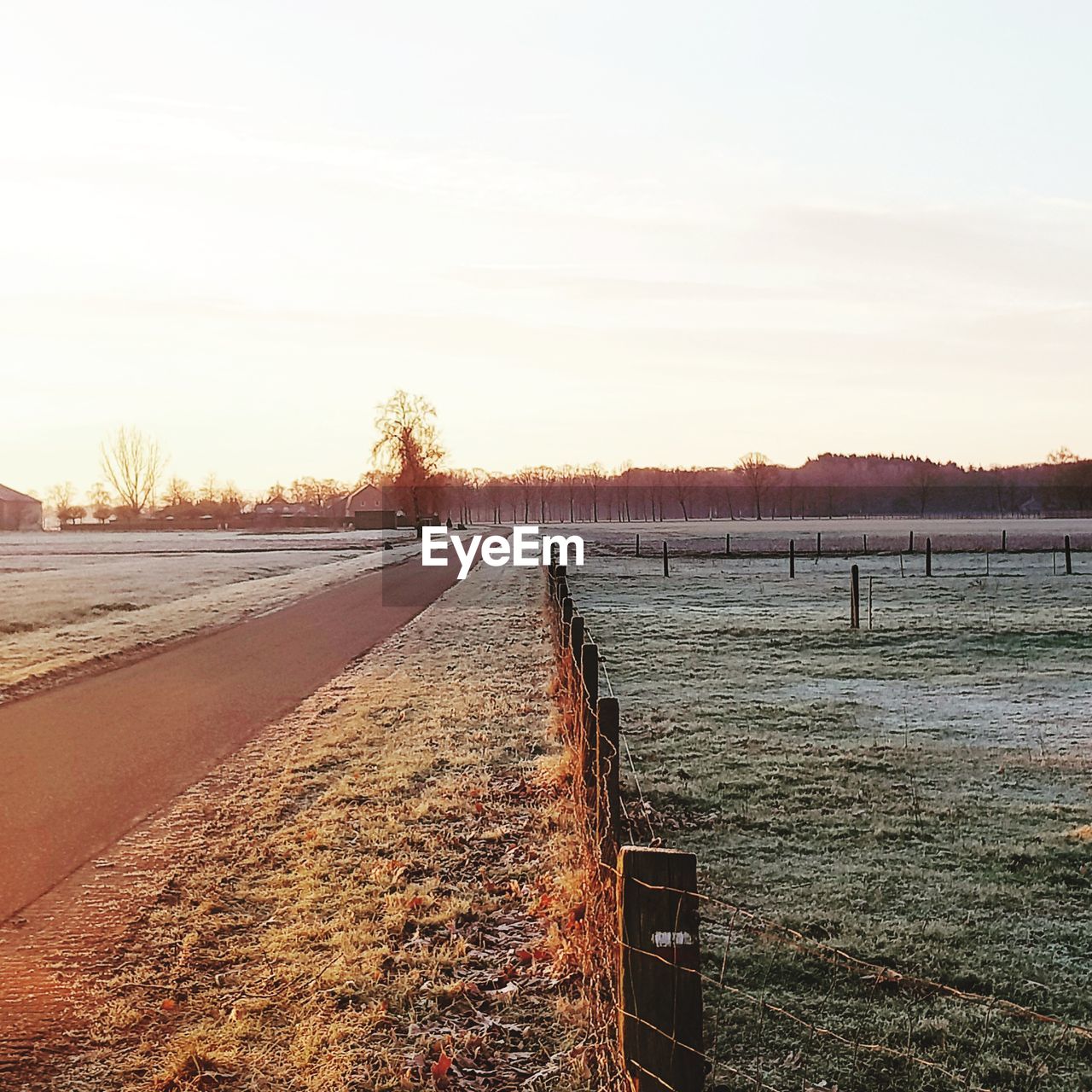 SNOW COVERED LANDSCAPE AGAINST CLEAR SKY DURING SUNSET