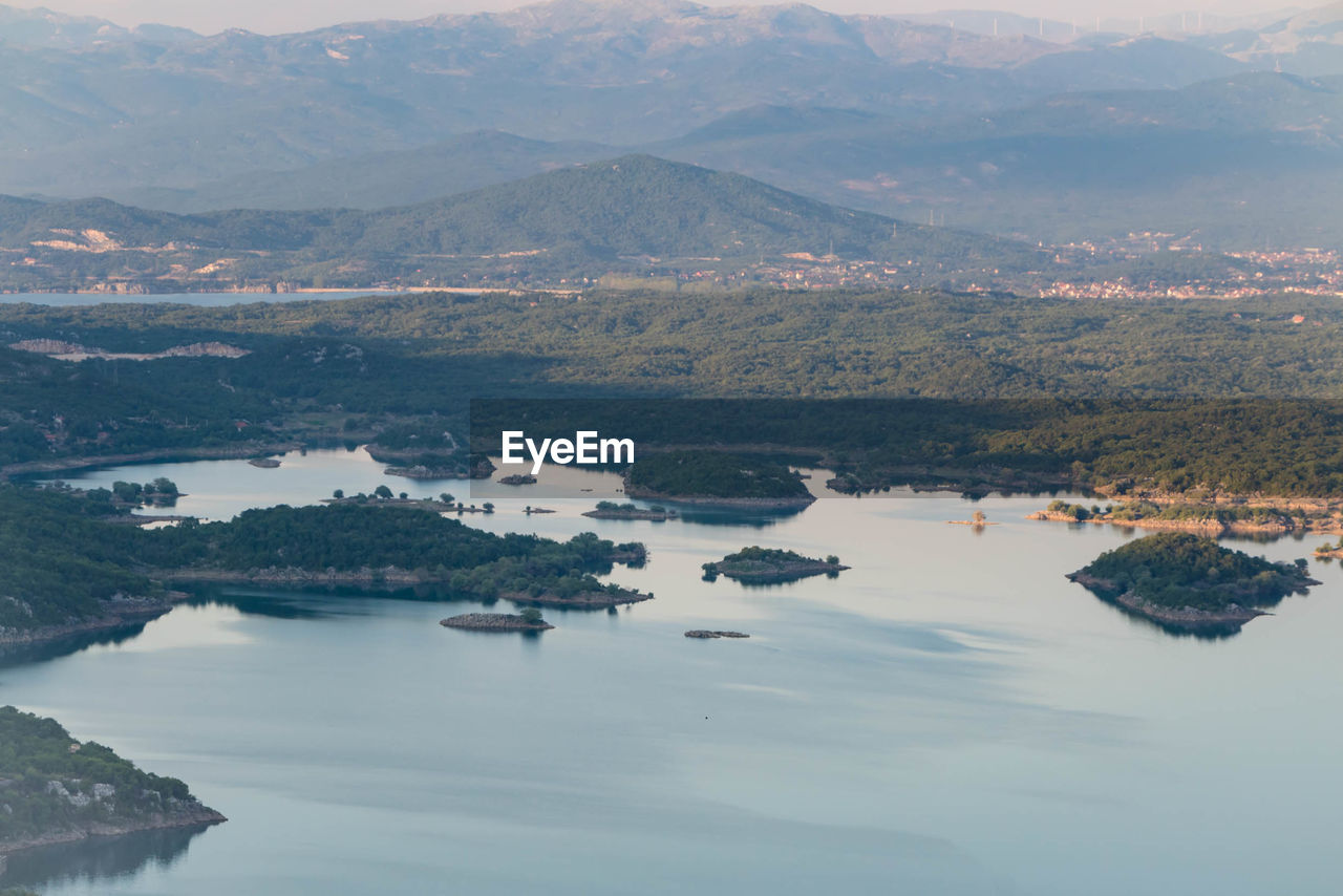 Aerial view of lake with mountains in background