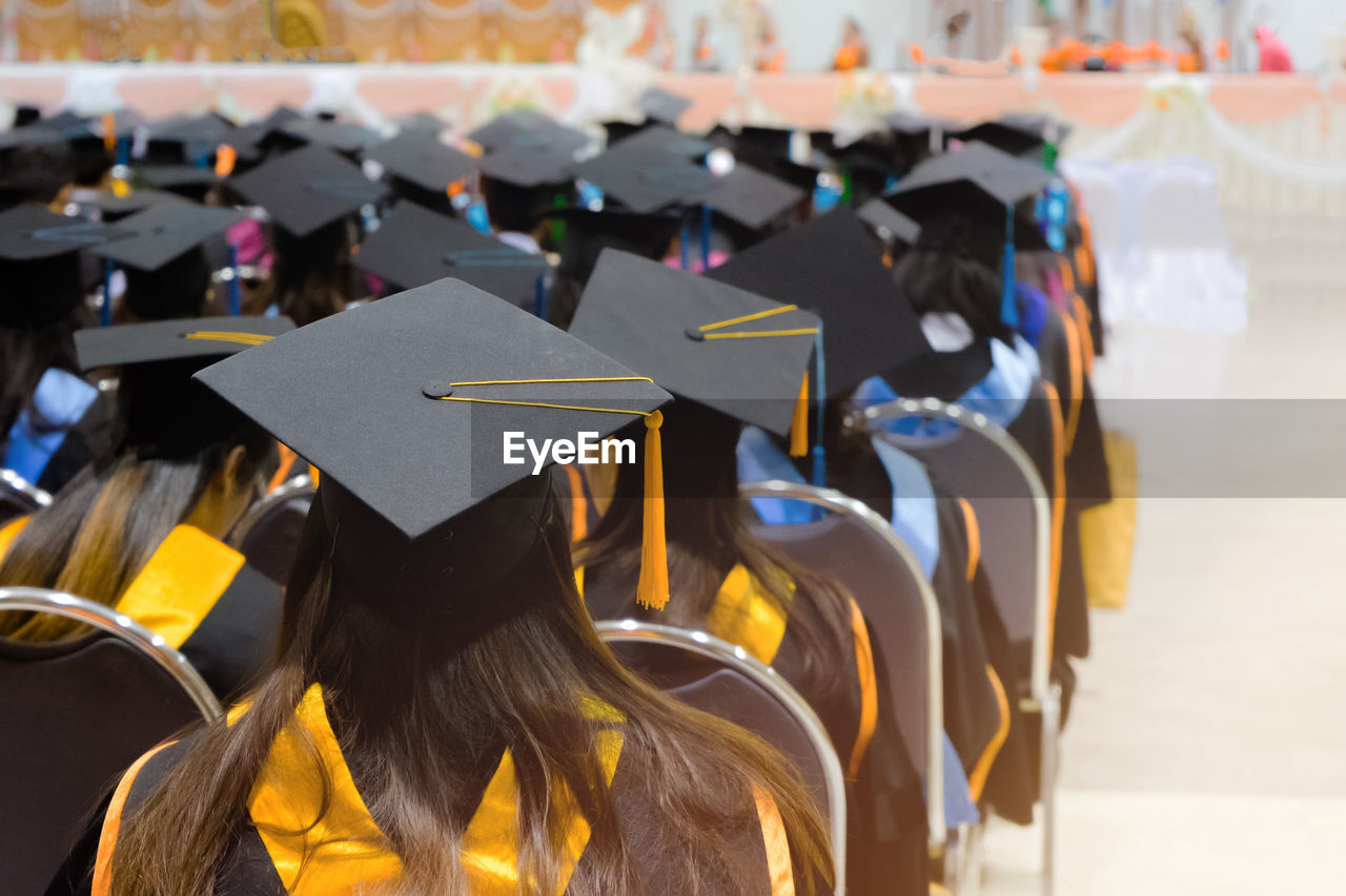 Students sitting in auditorium during graduation ceremony