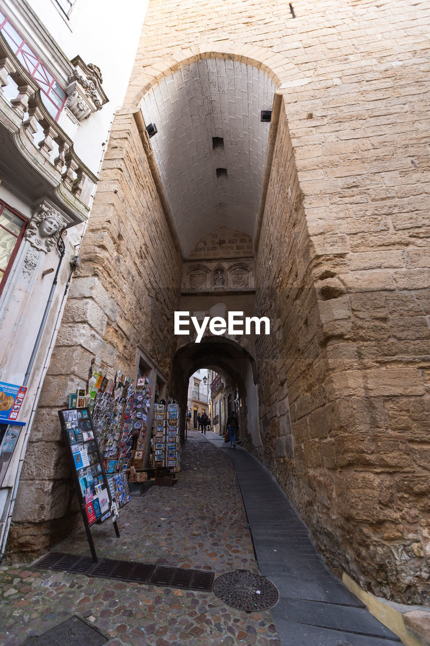 EMPTY ALLEY AMIDST BUILDINGS