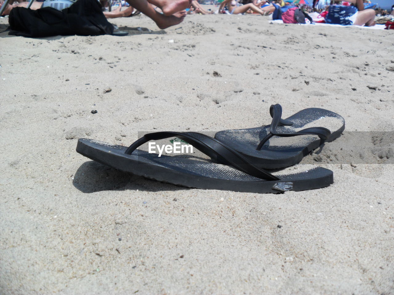 LOW SECTION OF PEOPLE ON SANDY BEACH