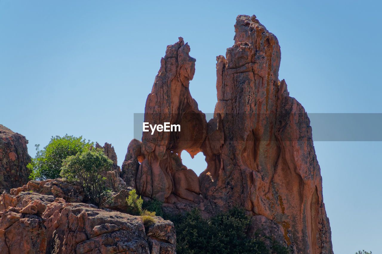 LOW ANGLE VIEW OF ROCK FORMATION AGAINST SKY