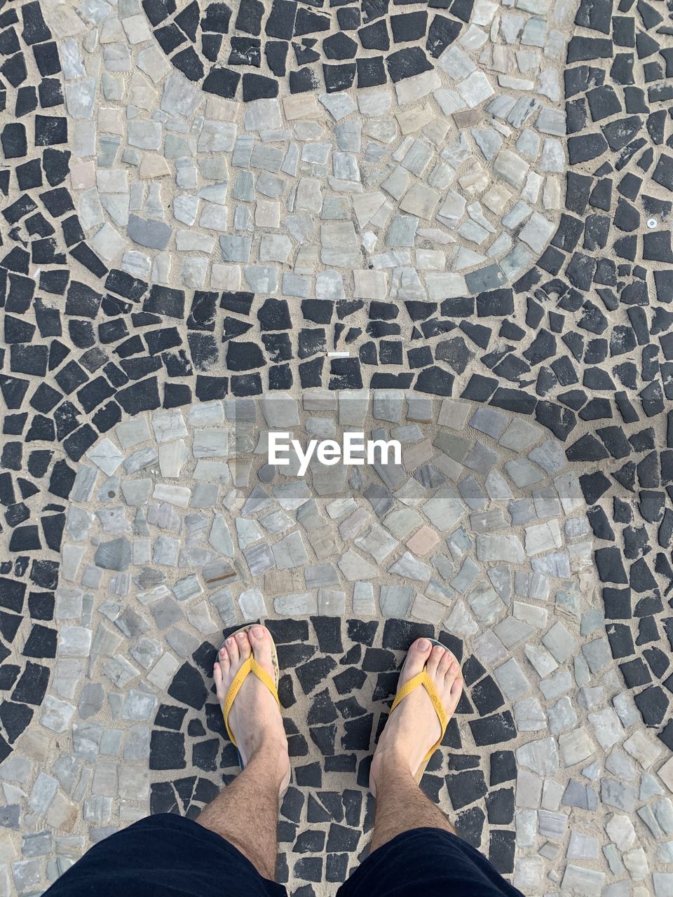 Standing on the ipanema beach cobblestone pattern