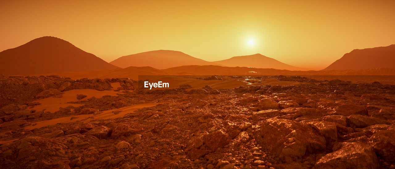 Scenic view of mountains against sky during sunset