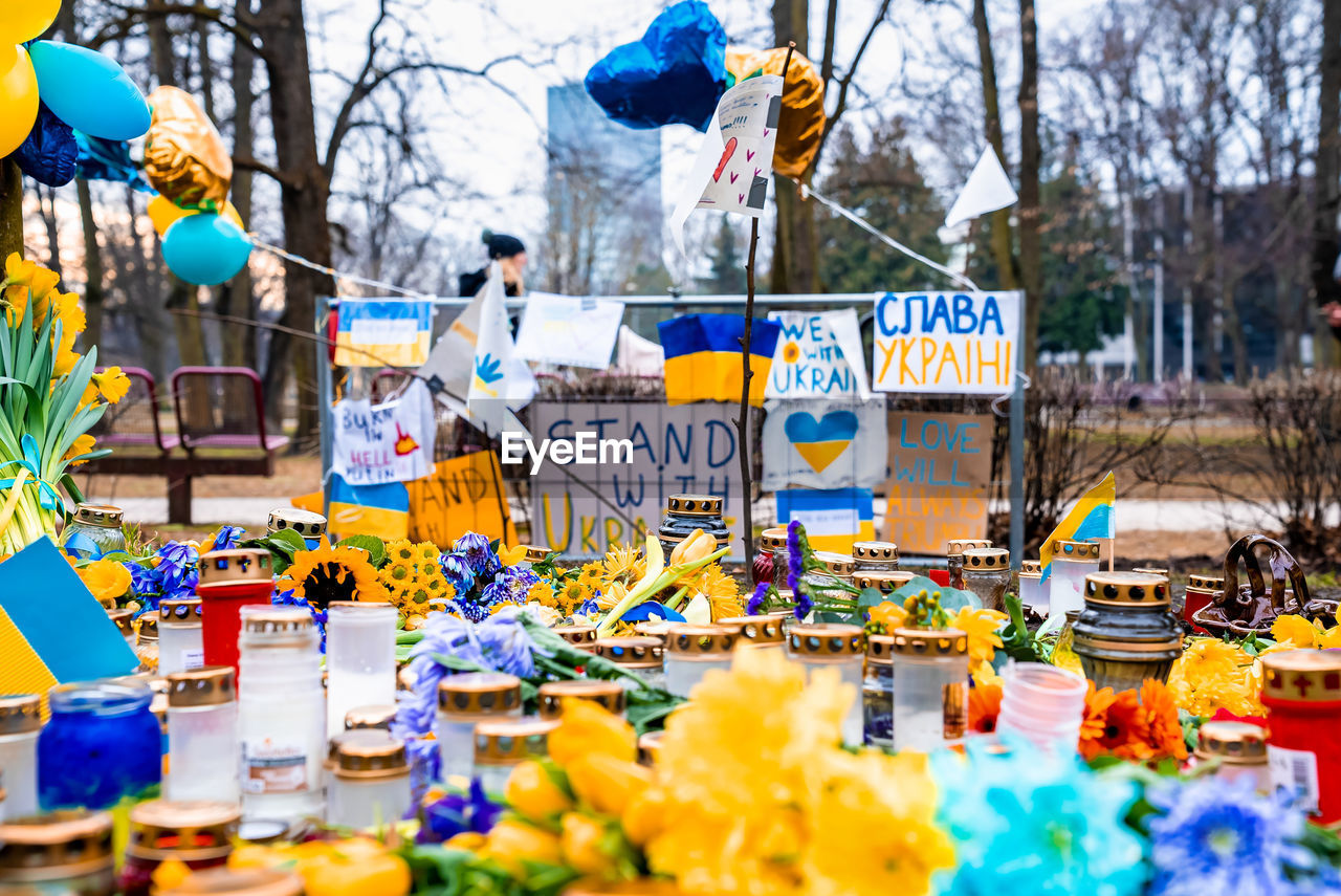 Thousands candles and flowers standing on the street during the war in ukraine