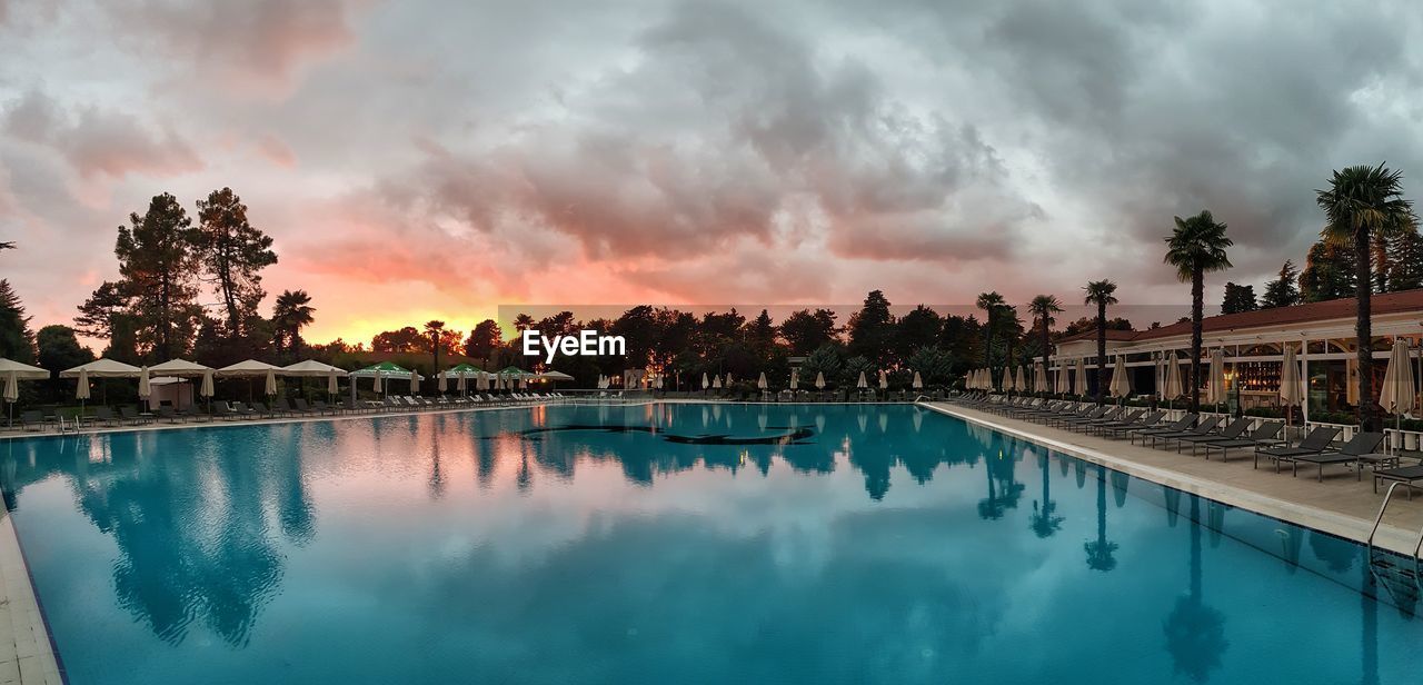 PANORAMIC SHOT OF SWIMMING POOL AGAINST SKY