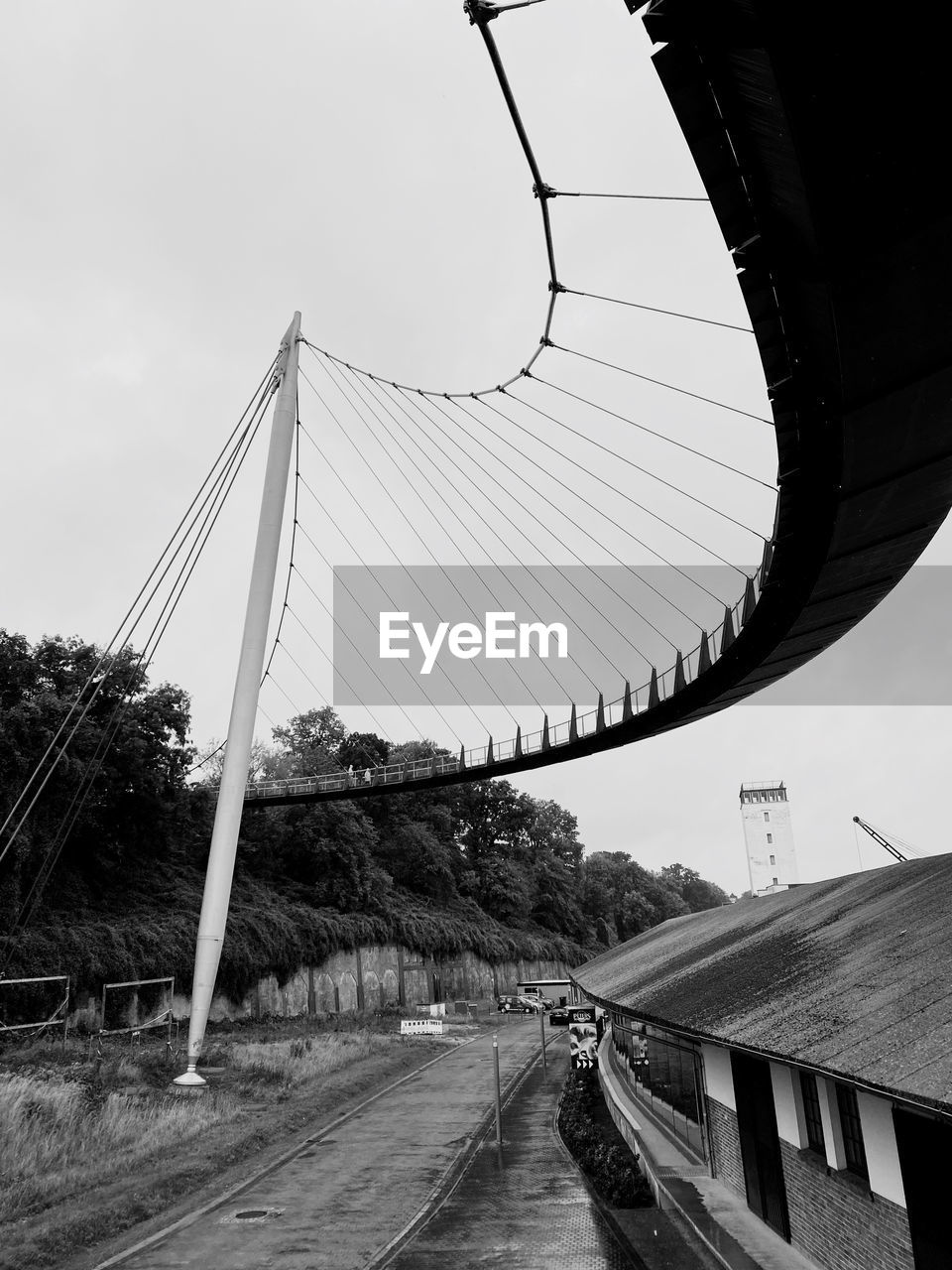 STREET BY BRIDGE AGAINST SKY