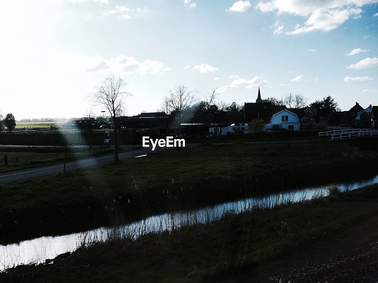 VIEW OF RIVER WITH BUILDINGS IN BACKGROUND