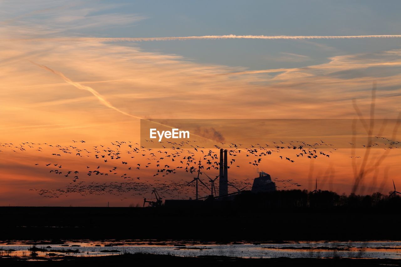 Scenic view of silhouette land against sky during sunset