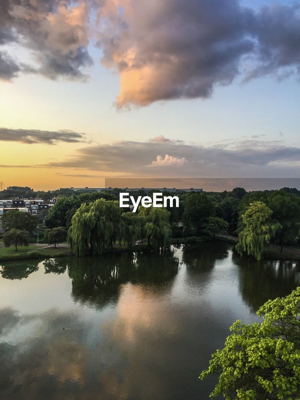 Scenic view of lake against sky at sunset