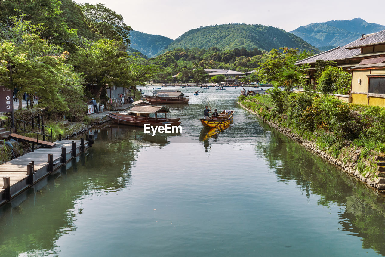 SCENIC VIEW OF RIVER AMIDST MOUNTAINS