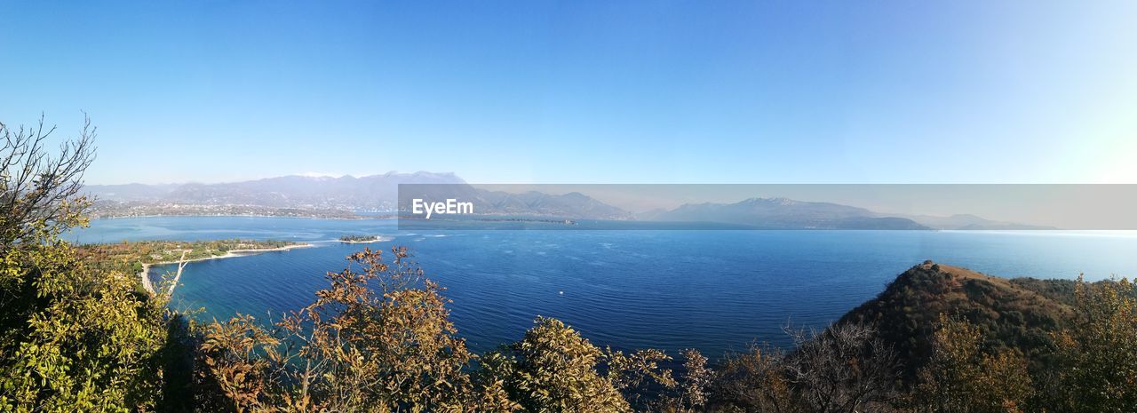 Scenic view of sea against clear blue sky