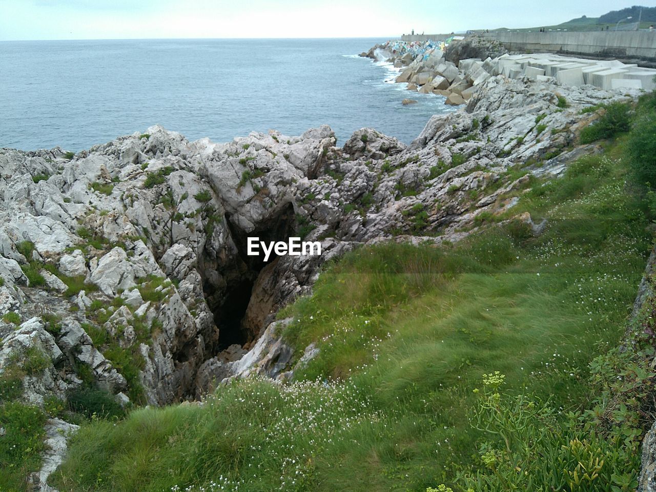 SCENIC VIEW OF SEA WITH ROCKS IN BACKGROUND