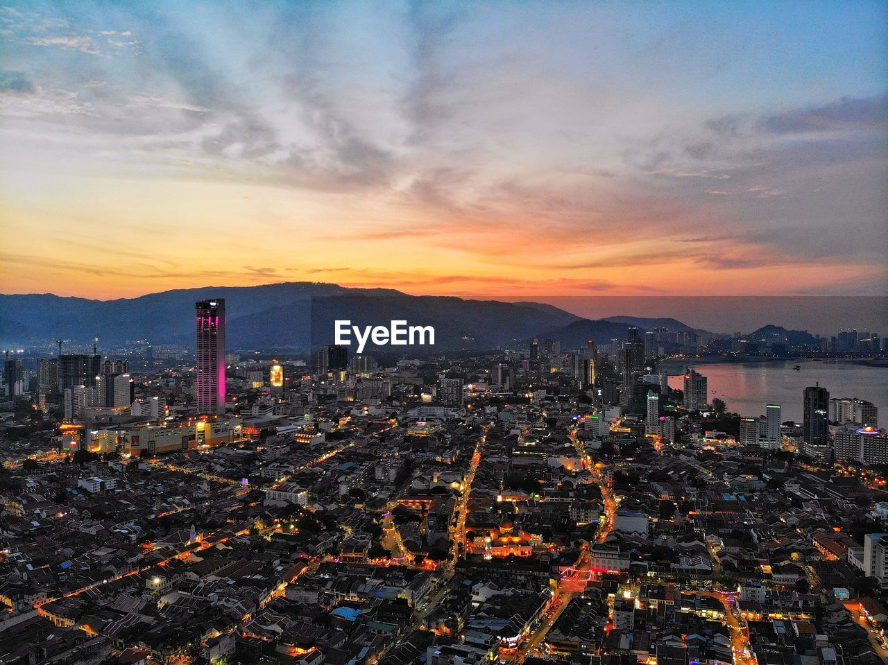 High angle view of illuminated buildings against sky during sunset