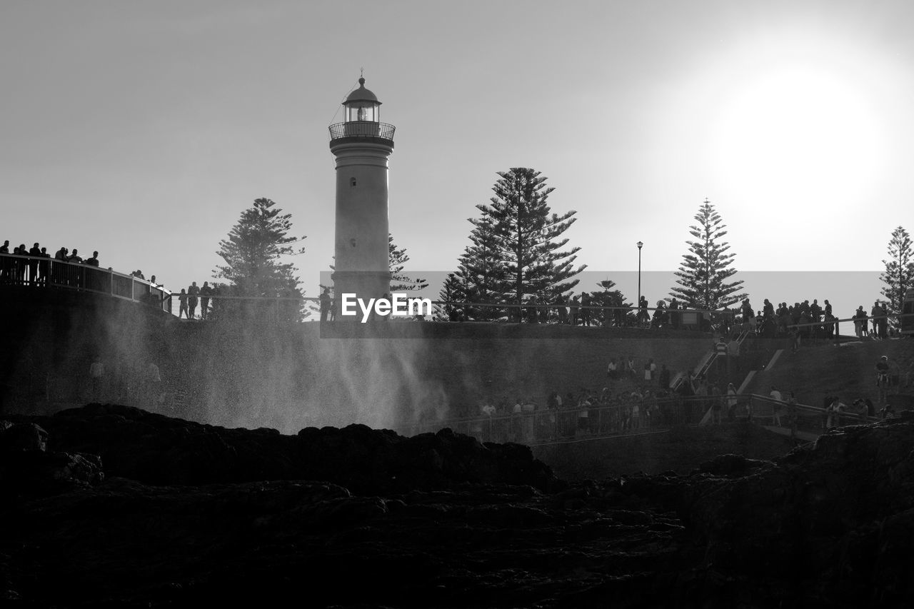 Low angle view of lighthouse against sky at kiama blowhole on sunny day