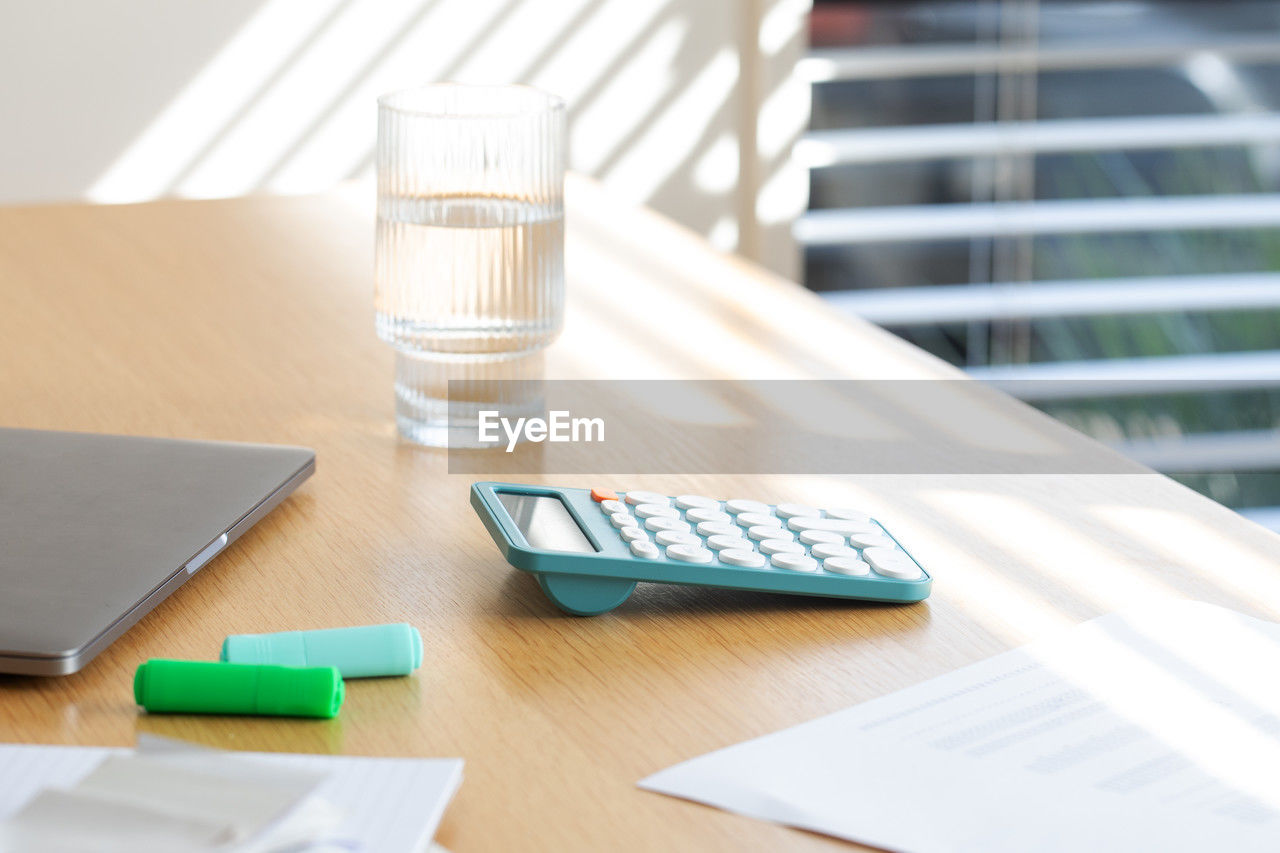 table, business, furniture, office, wireless technology, indoors, desk, writing, technology, communication, computer, no people, drink, corporate business, document, paper, drinking glass, finance, drinking water, glass, water, laptop, food and drink, note pad, day