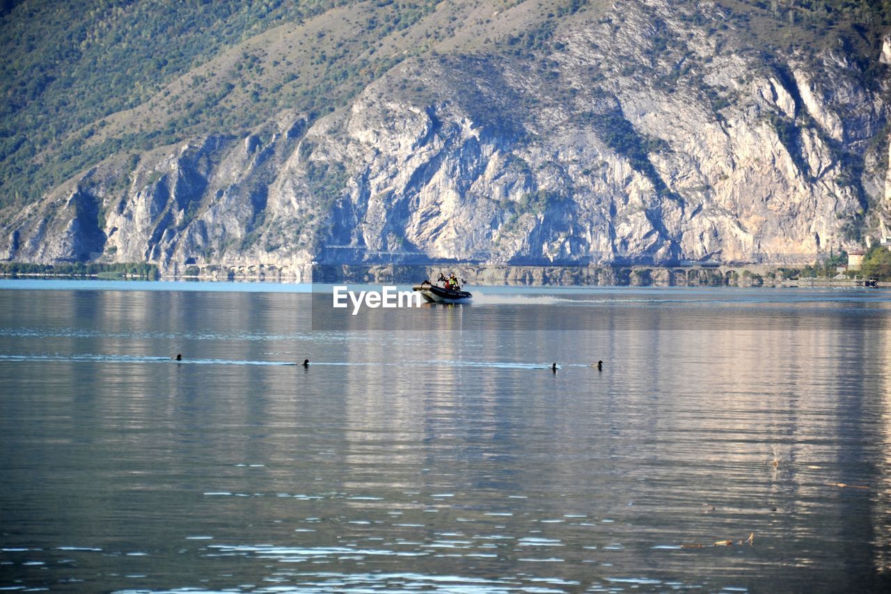 Scenic view of sea by mountain