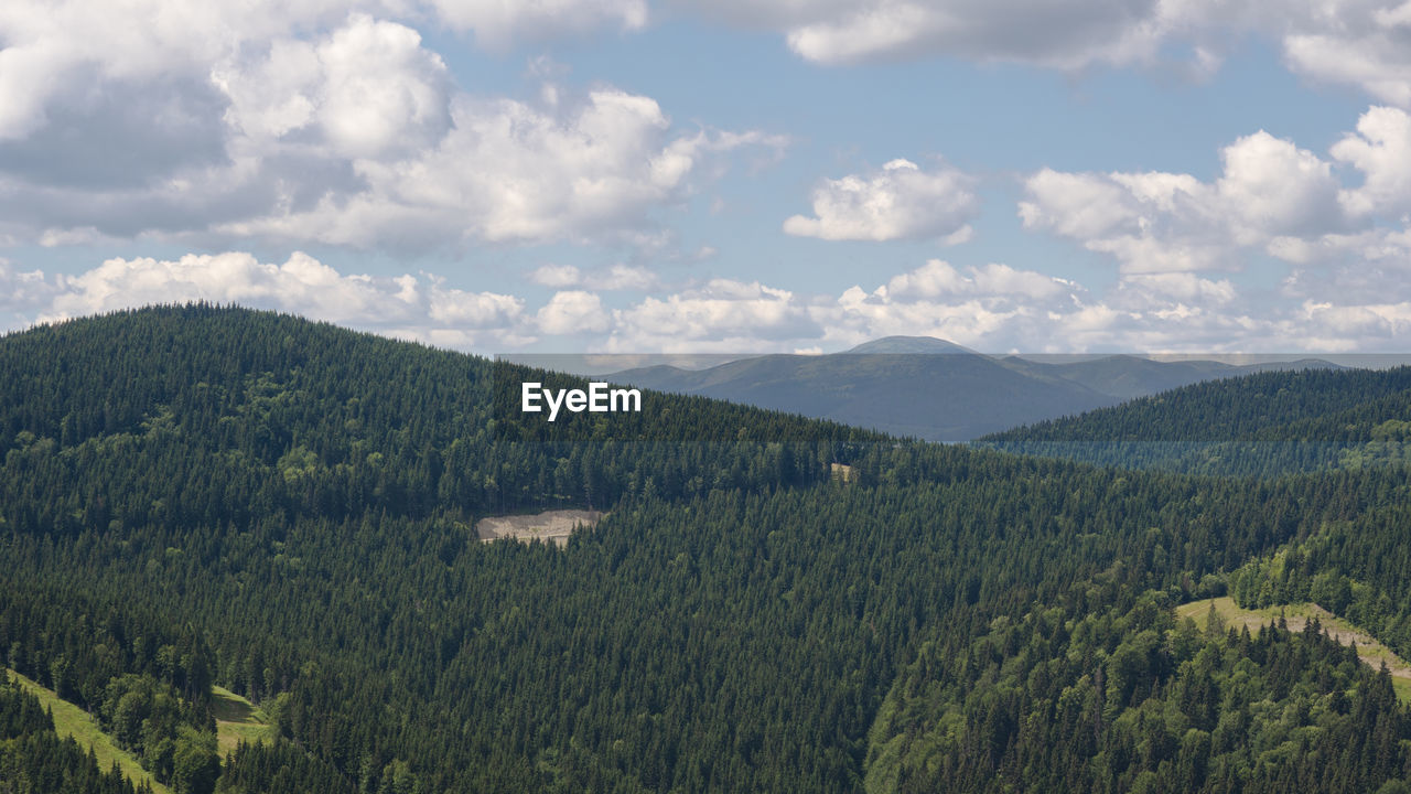 SCENIC VIEW OF FIELD AND MOUNTAINS AGAINST SKY