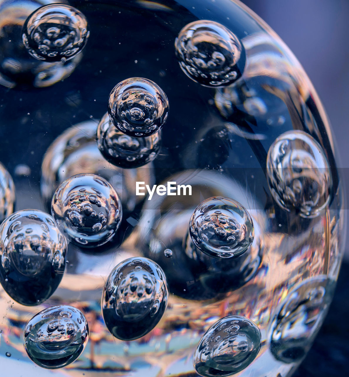 CLOSE-UP OF WATER DROPS ON BUBBLES