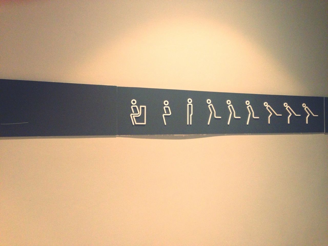 Close-up of toilet sign on wall