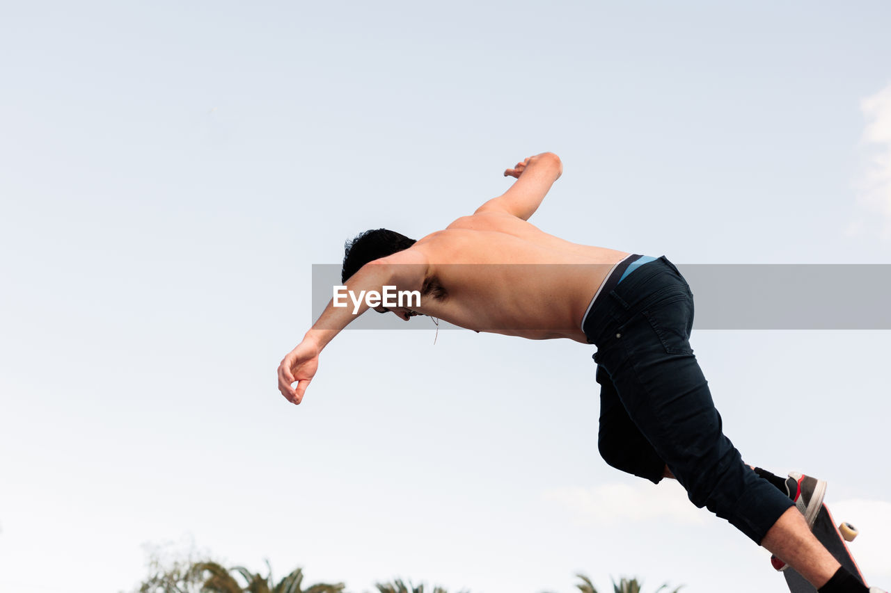 Young skater standing at the top of the skate ramp