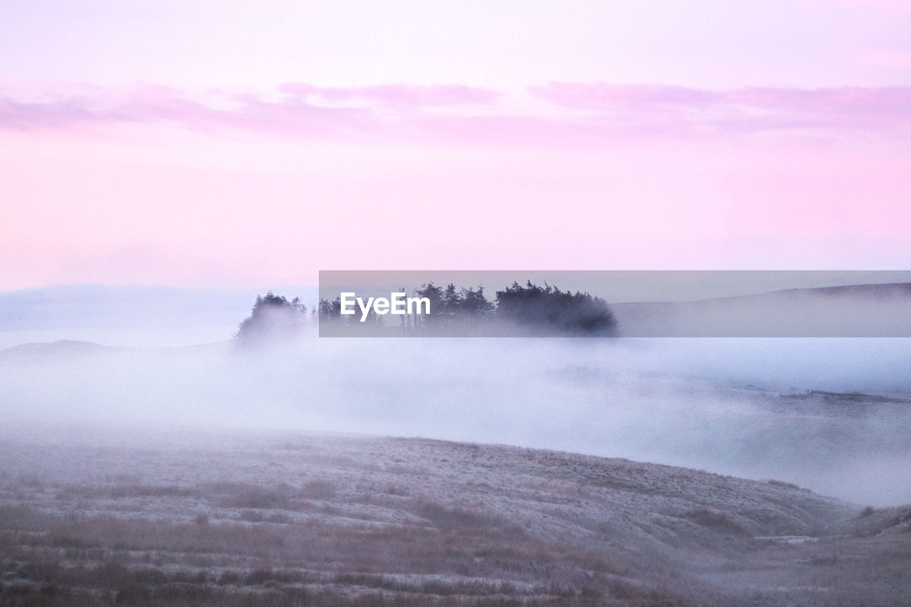 Scenic view of landscape against sky during sunset