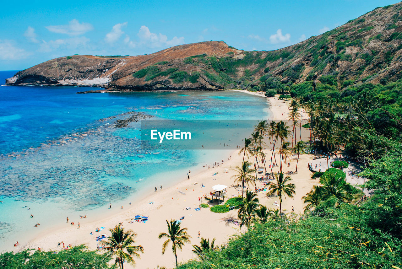 Scenic view of sea and mountains against sky