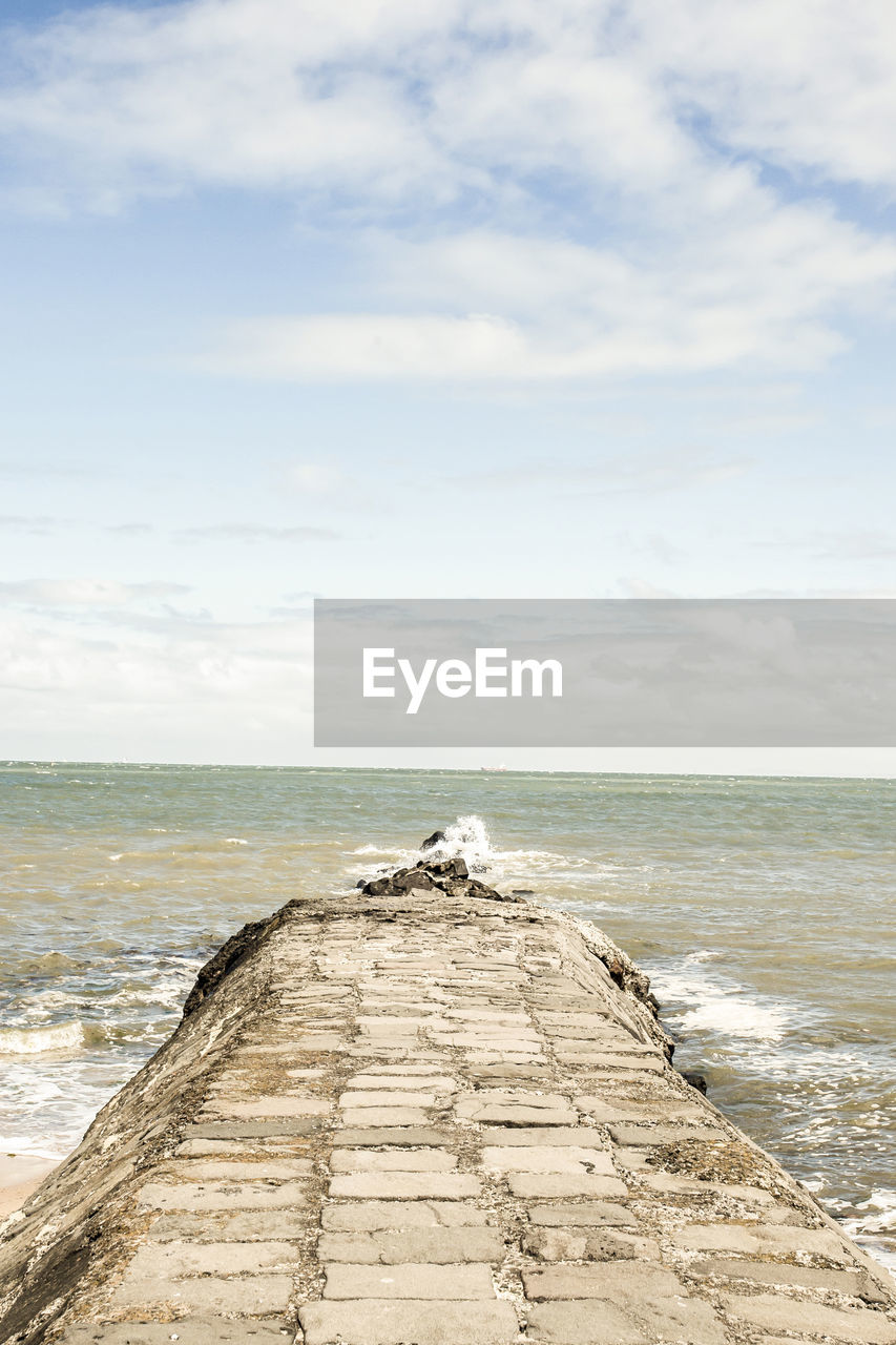 Scenic view of sea against cloudy sky