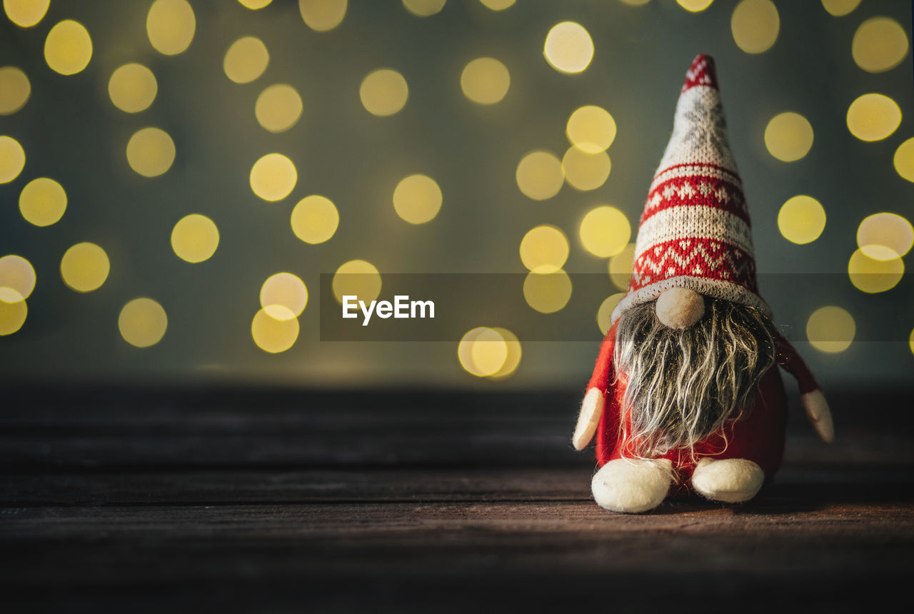 New year's gnom with a gift on wooden background