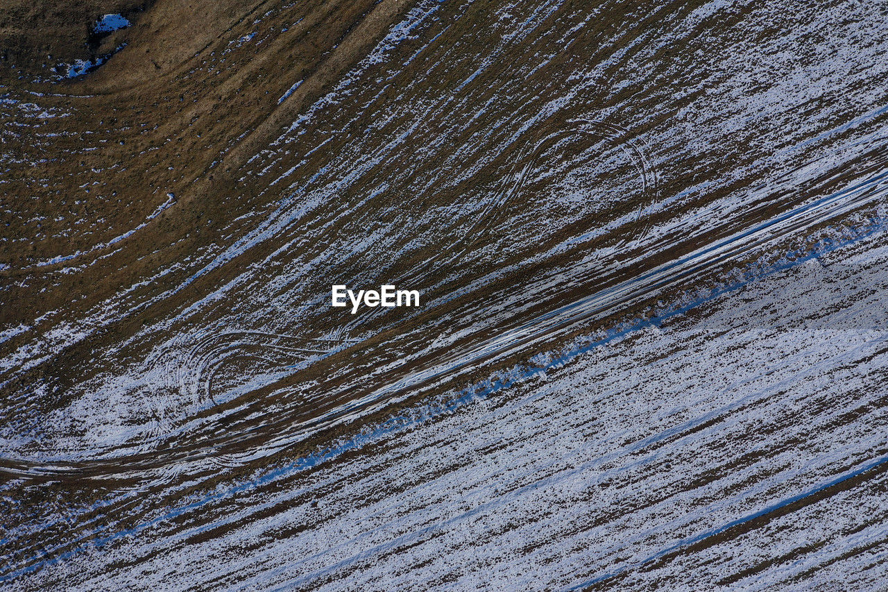 full frame, wood, backgrounds, pattern, blue, textured, no people, nature, high angle view, floor, day, outdoors, snow, soil, close-up, asphalt, land, wall, environment