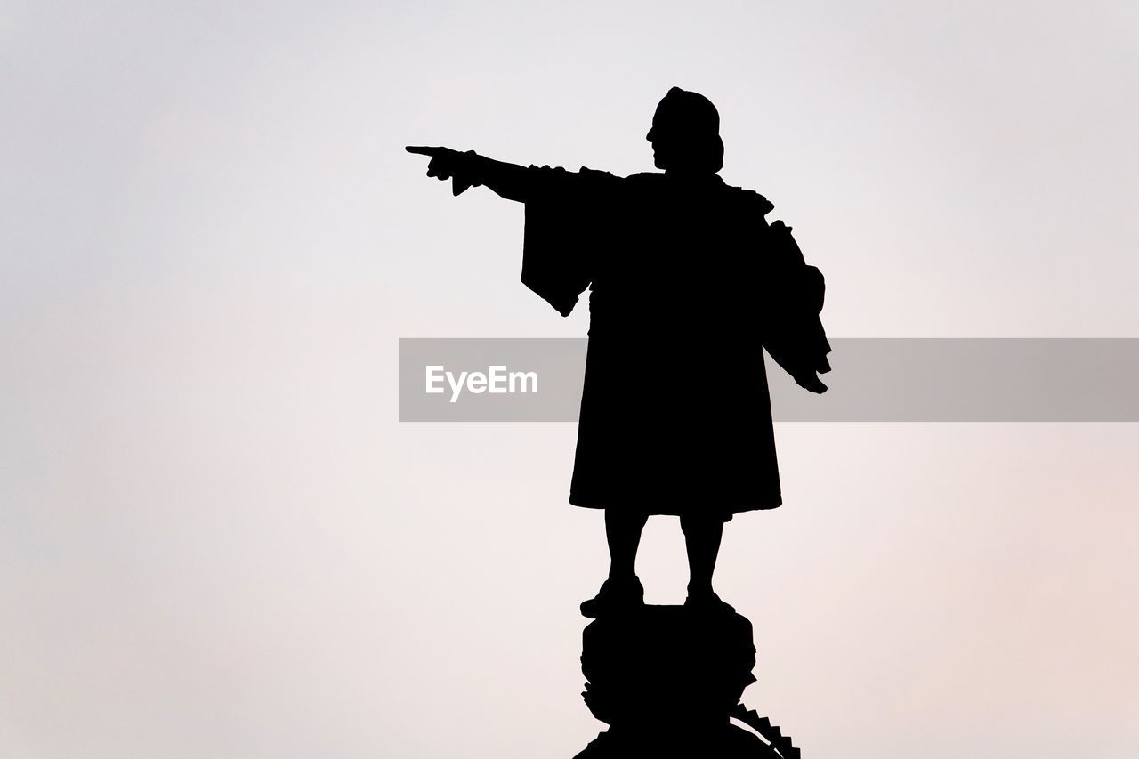 SILHOUETTE BOY STANDING AGAINST CLEAR SKY