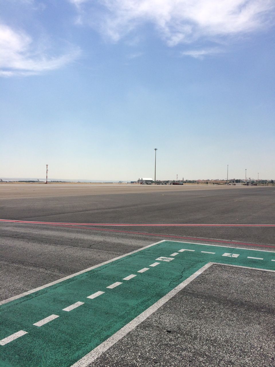 Empty runway against blue sky at airport