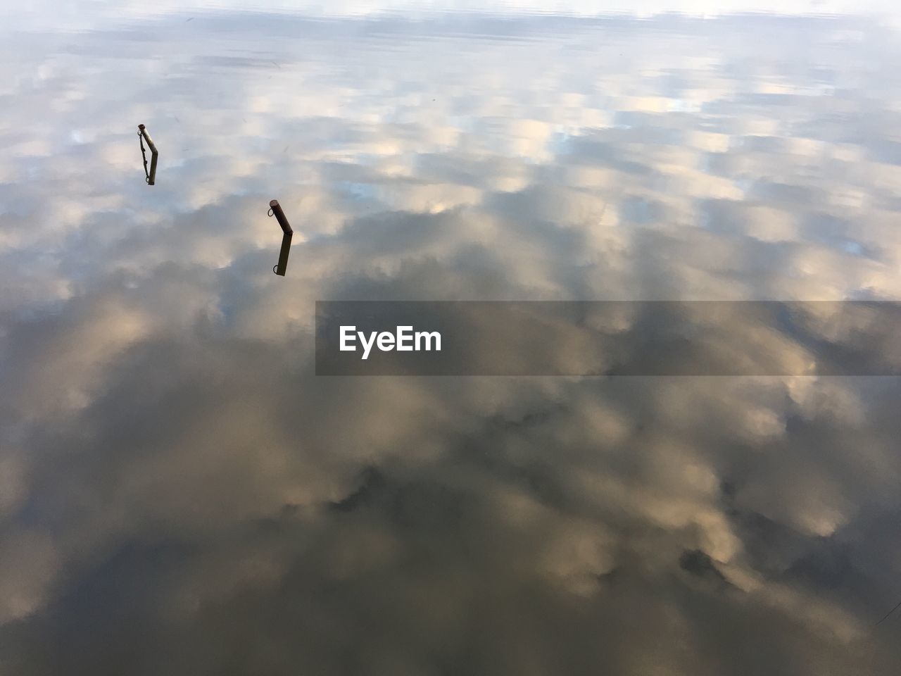 BIRD FLYING OVER LAKE AGAINST SKY