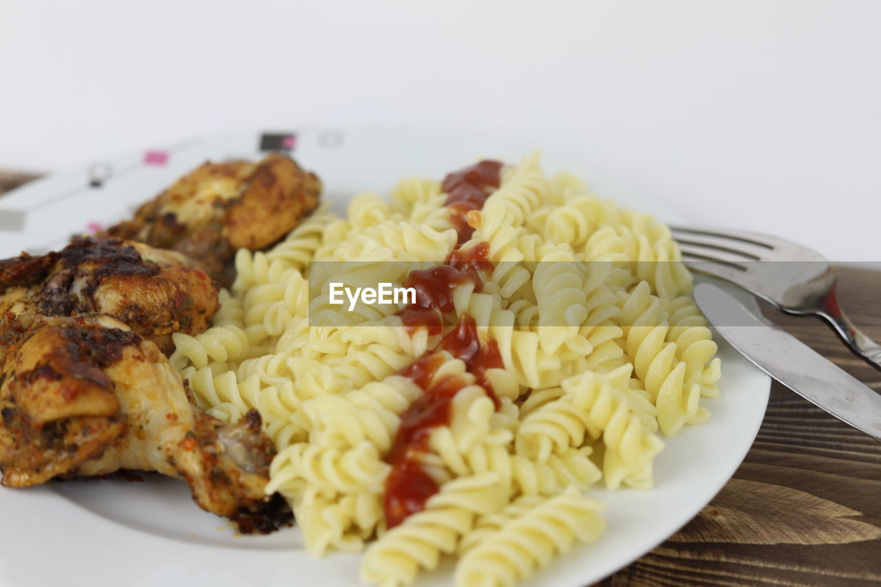 food, food and drink, fusilli, plate, rotini, freshness, fork, cuisine, dish, healthy eating, eating utensil, indoors, kitchen utensil, wellbeing, meal, close-up, spaghetti, no people, pasta, meat, vegetable, produce, italian food, fast food, table, vegetarian food, still life, dinner