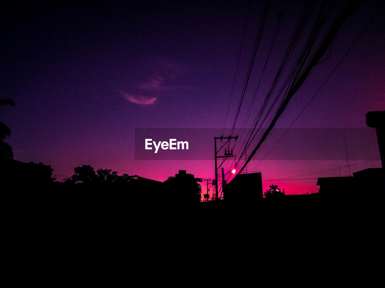 LOW ANGLE VIEW OF SILHOUETTE ELECTRICITY PYLONS AGAINST SKY