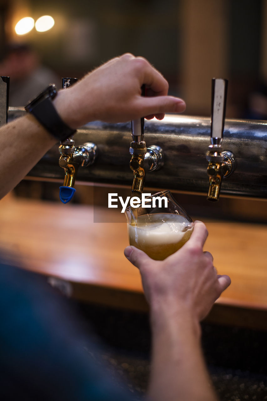 A man pours a beer at a brewery in the dalles, oregon.