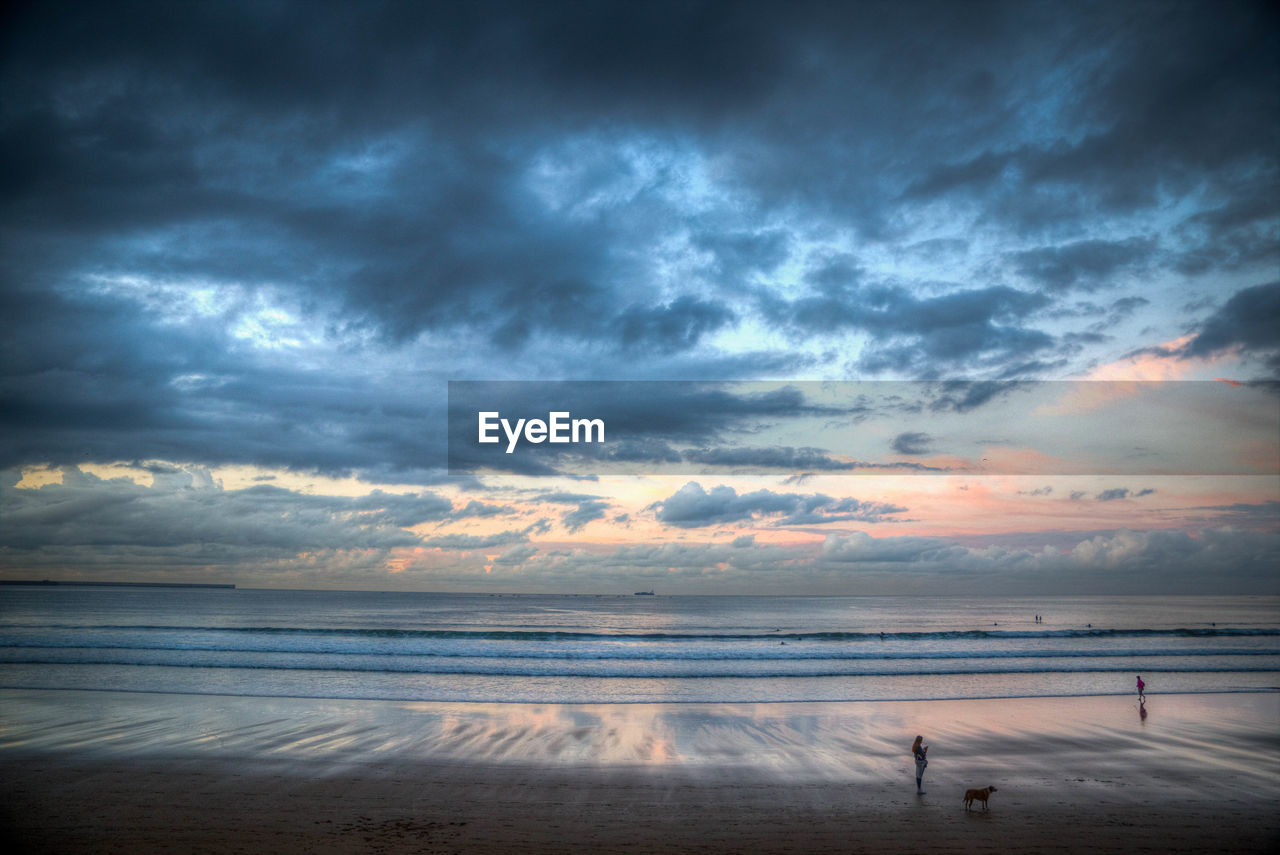 Scenic view of beach against sky during sunset