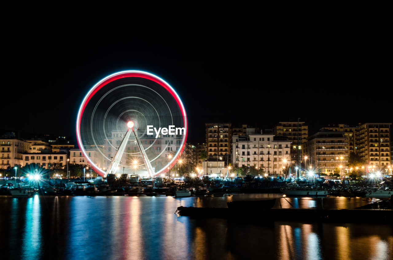 ILLUMINATED FERRIS WHEEL AT NIGHT