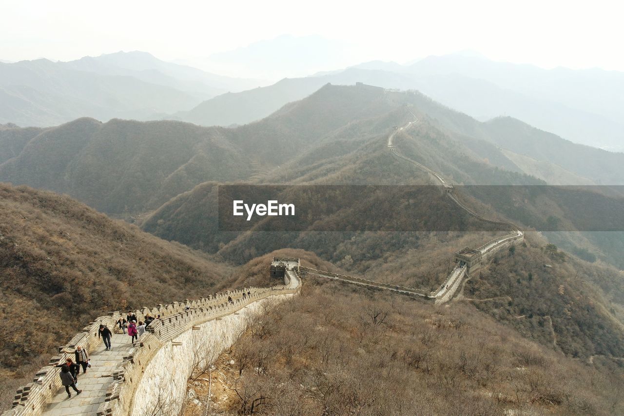 HIGH ANGLE VIEW OF PEOPLE WALKING ON MOUNTAIN