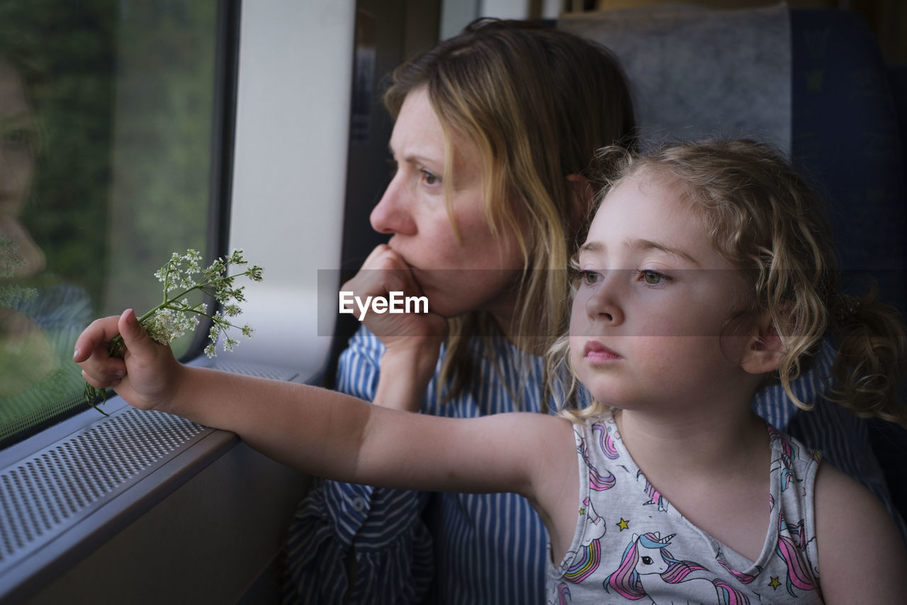 Portrait of mother and girl looking at camera