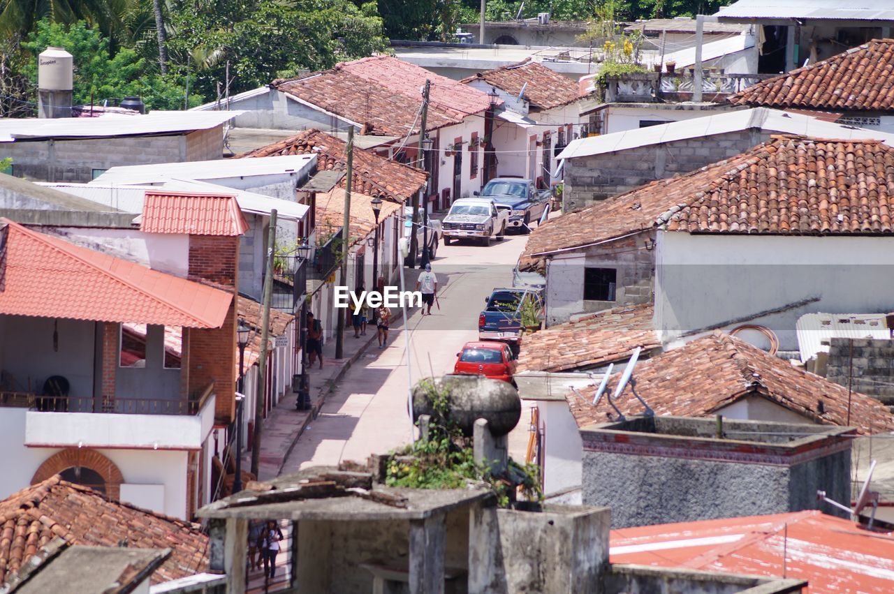 HIGH ANGLE VIEW OF MAN WITH UMBRELLA